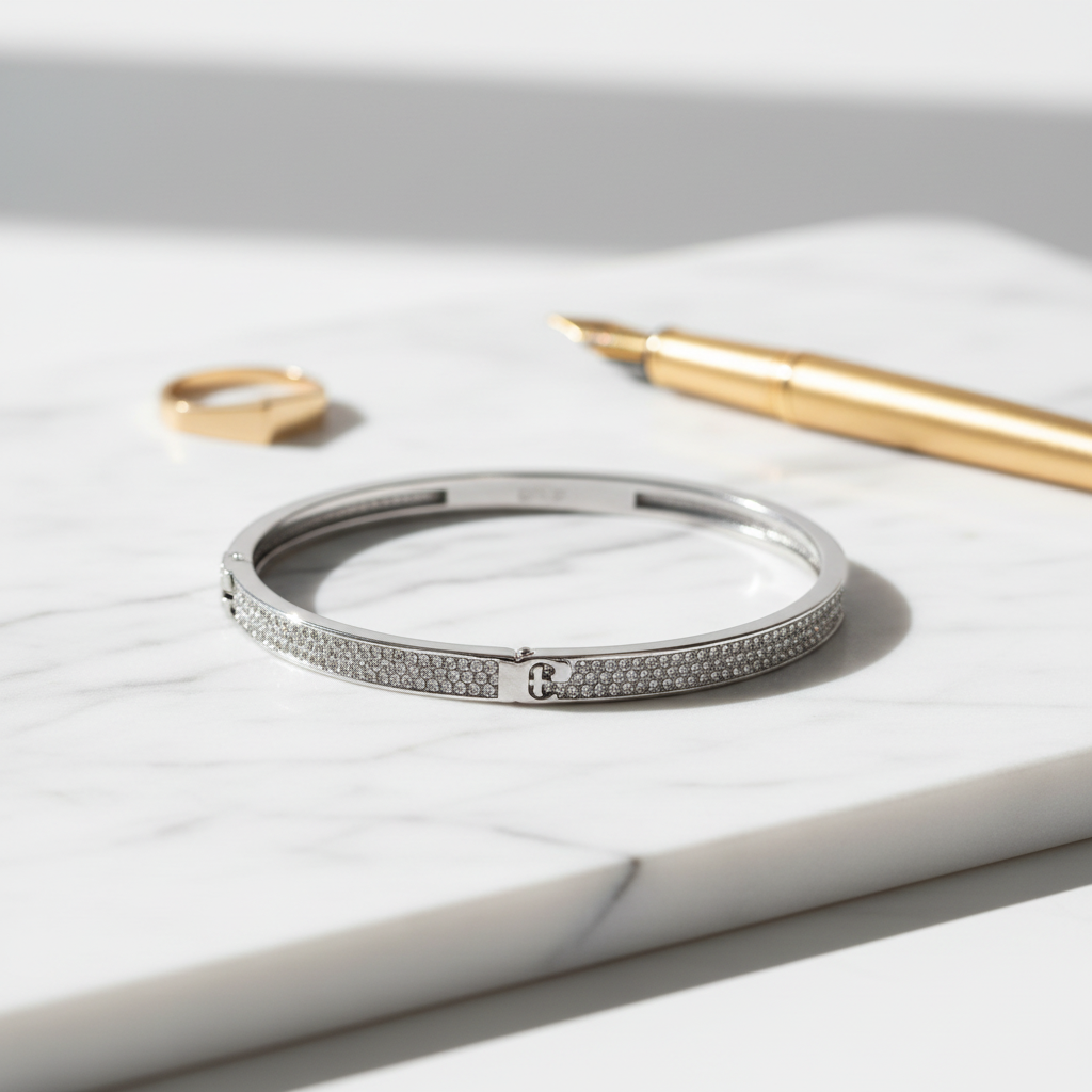 Tory Burch Serif-T Pavé Hinged Bracelet on marble surface