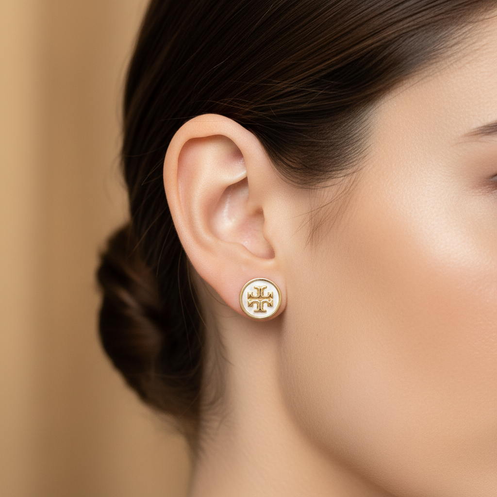 Tory Burch Kira Icon Stud Earrings with Mother of Pearl ear close-up