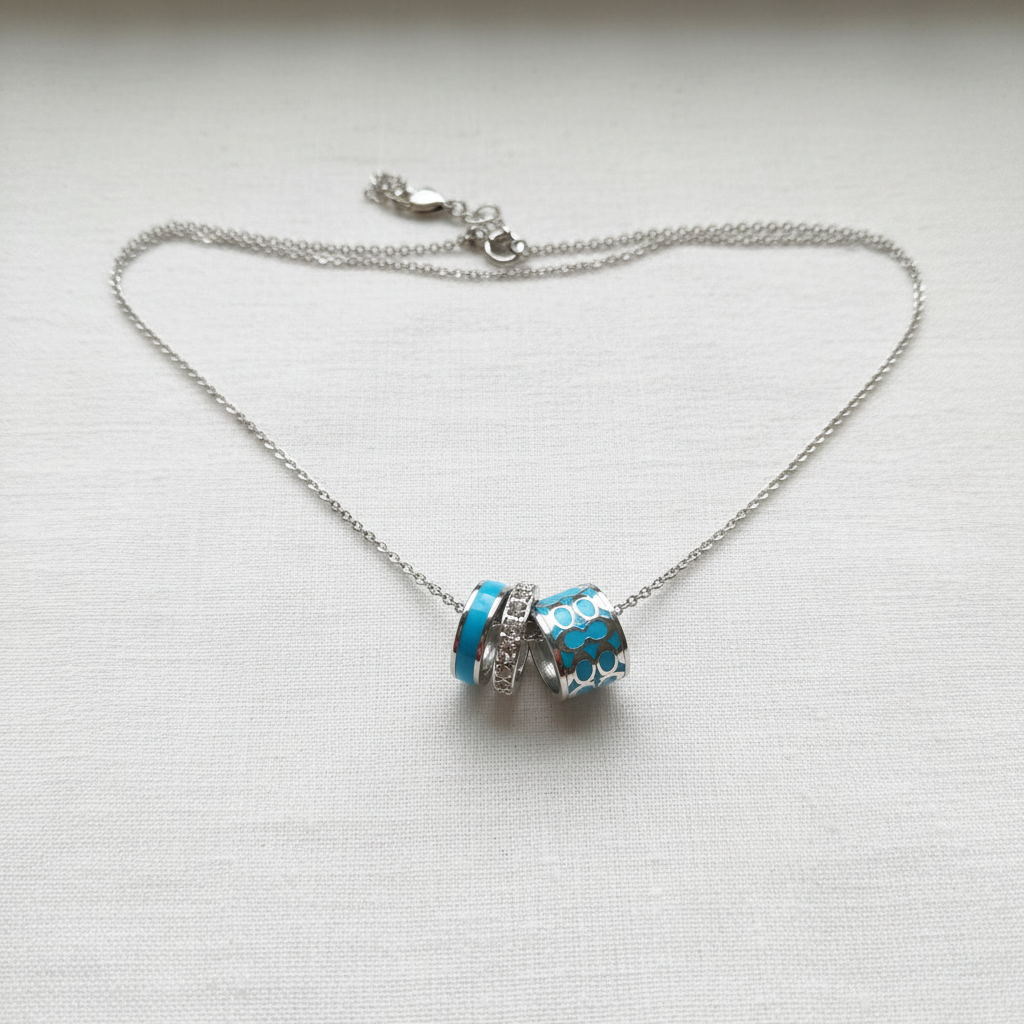 Coach Blue Enamel Necklace on white linen