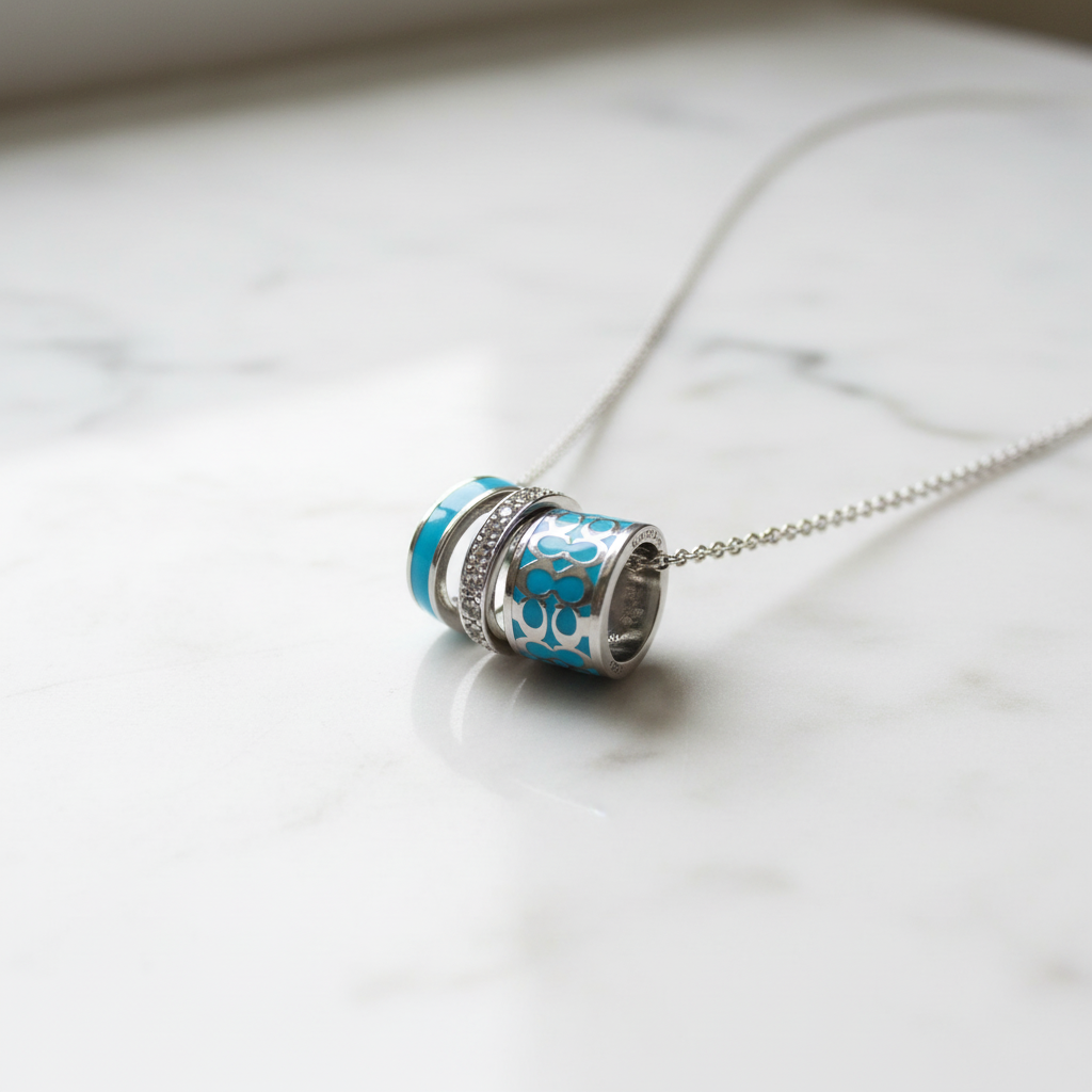 Coach Blue Enamel Necklace on marble