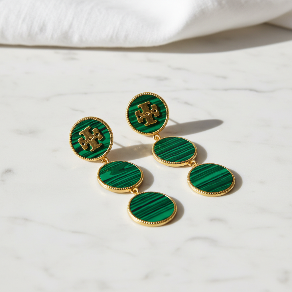 Tory Burch Malachite Dangle Earrings on marble surface, editorial lifestyle shot