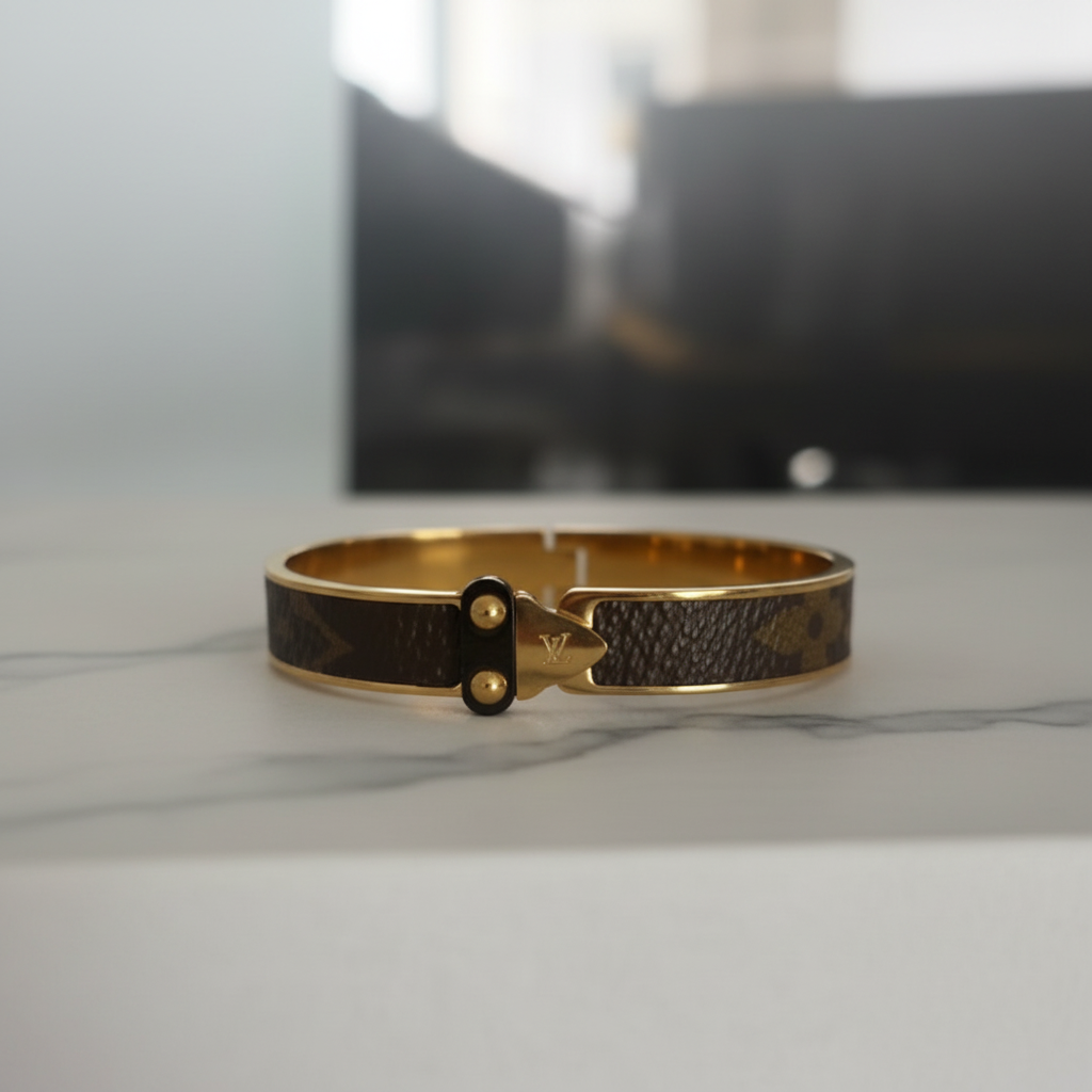 LV Monogram Bangle on marble surface, editorial lifestyle shot