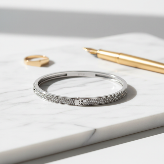 Tory Burch Serif-T Pavé Hinged Bracelet on marble surface