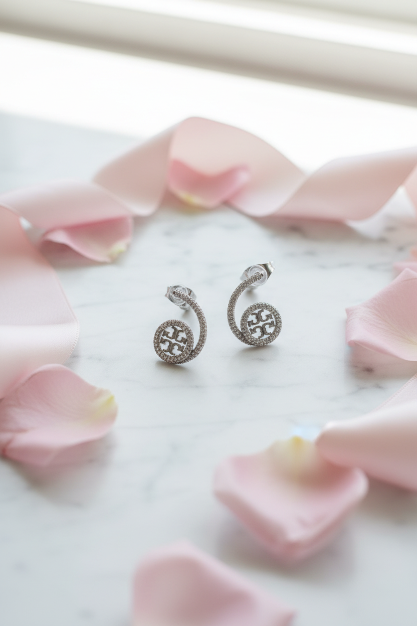 Tory Burch Logo Ear Climber Earrings flat lay with rose petals