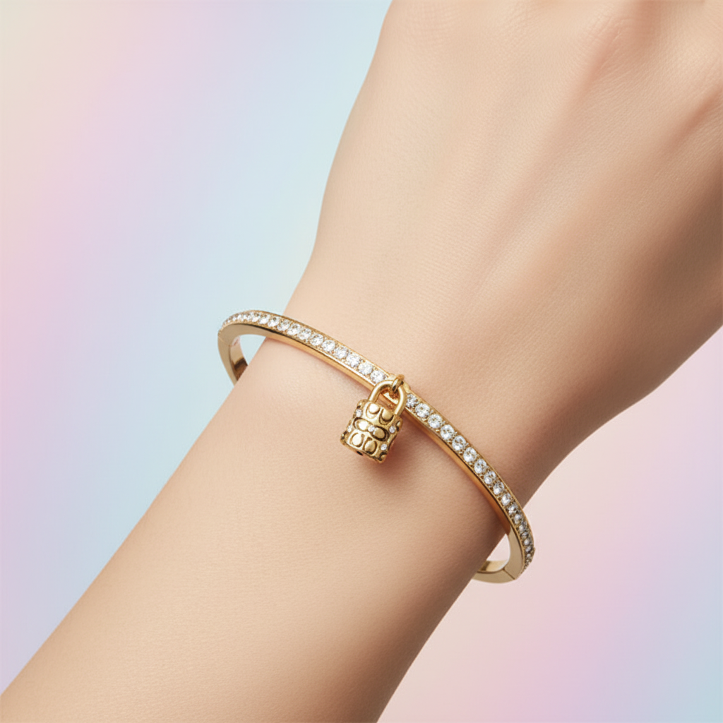 Coach Faux Stone Padlock Bangle editorial close-up on wrist
