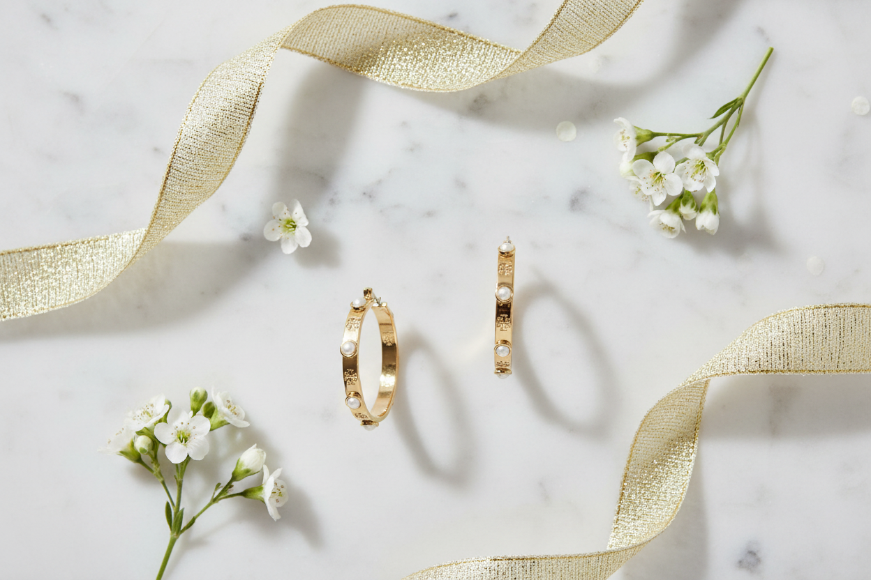 Tory Burch Miller Faux Pearl Hoop Earrings marble flat lay with white flowers