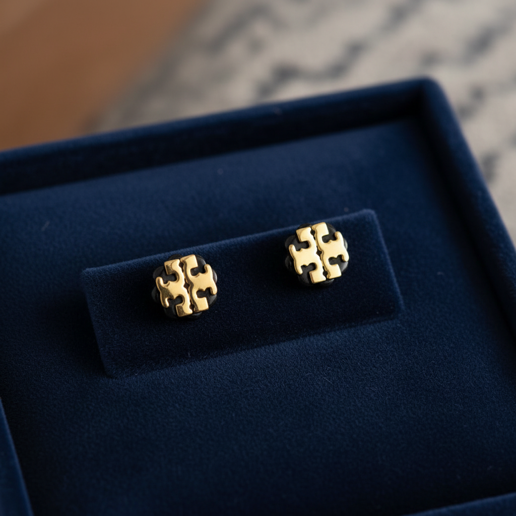 Tory Burch Logo Flower Resin Stud Earrings on navy velvet jewelry tray
