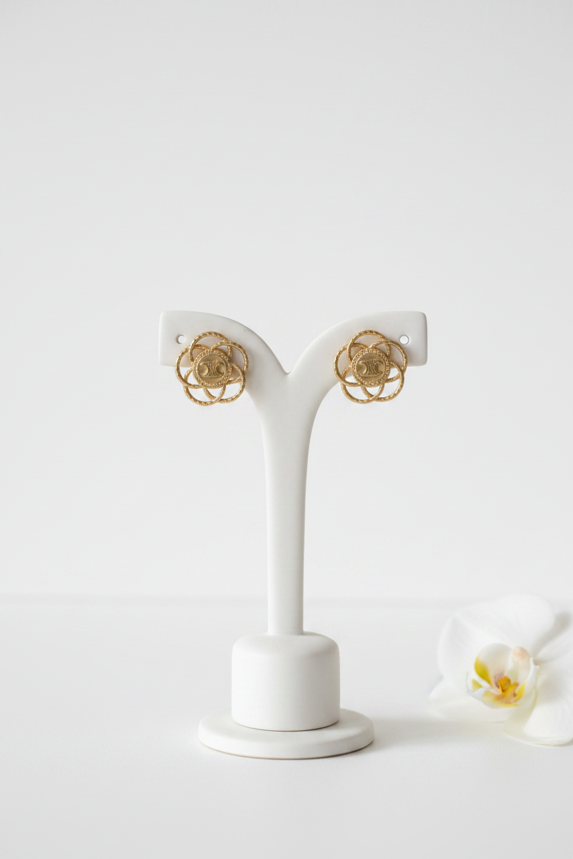 Celine Triomphe Brass Over Gold Floral Stud Earrings on ceramic stand