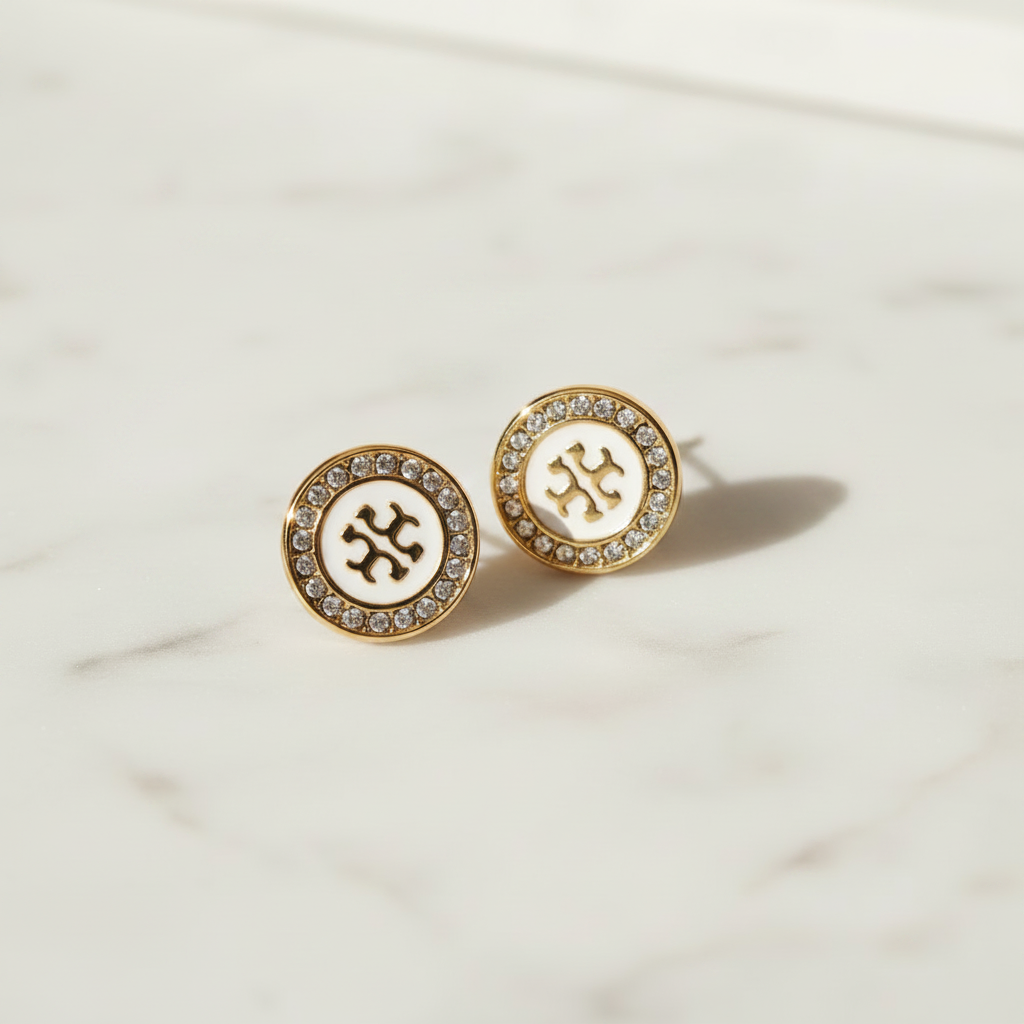 Tory Burch Kira Enamel Circle Stud Earrings styled flat lay