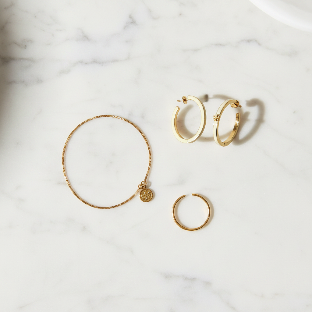 Tory Burch Kira white enamel hoop earrings styled flat lay