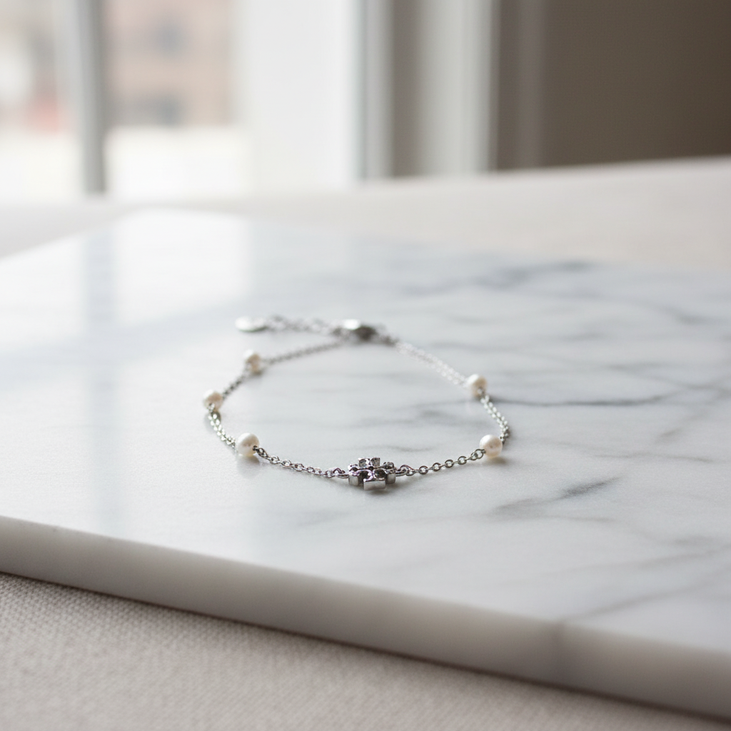 Tory Burch Kira Pearl Bracelet on marble surface