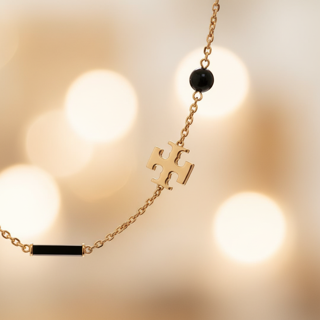 Tory Burch Kira Scattered Rosary Necklace in Tory Gold / Black – close-up detail