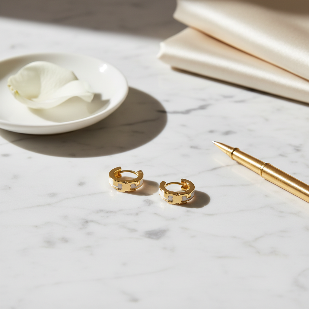 Tory Burch Serif T Huggie Earrings - White Marble Flat Lay