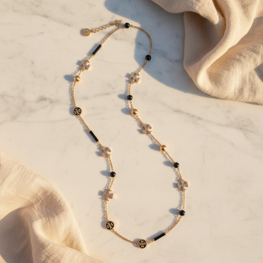 Tory Burch Kira Scattered Rosary Necklace in Tory Gold / Black – marble flat lay