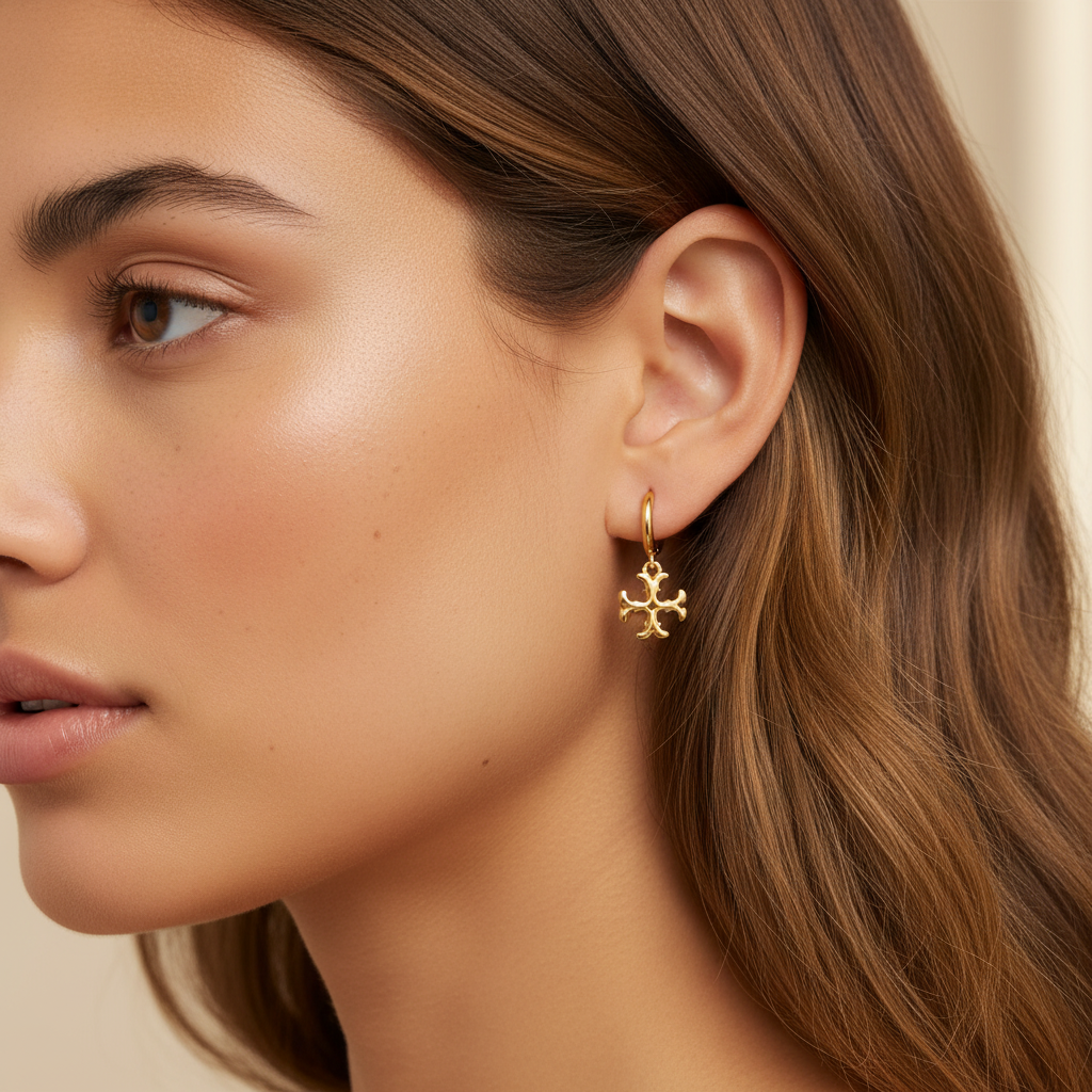 Tory Burch mini logo drop hoop earrings worn on ear