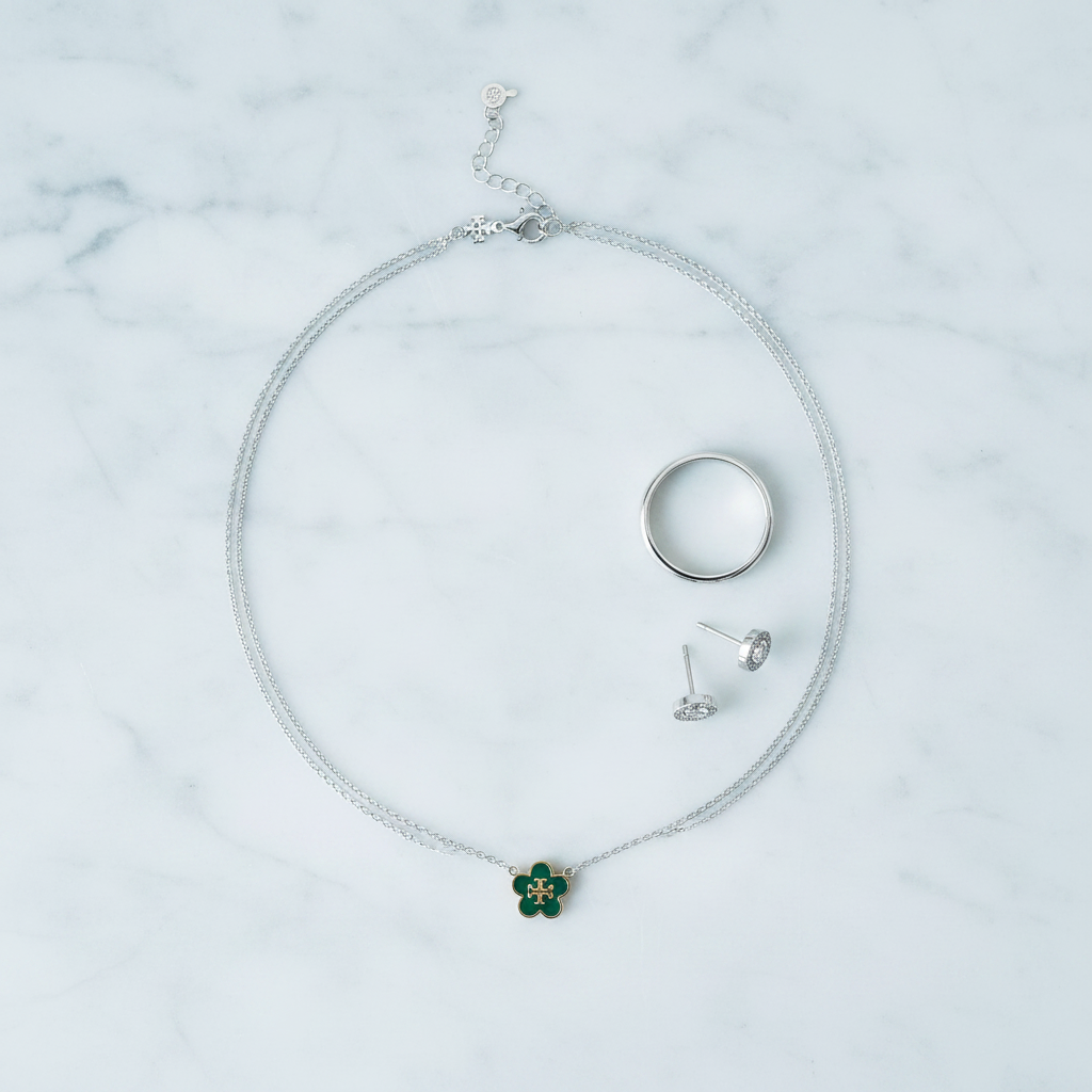 Tory Burch Forget Me Not necklace styled flat lay