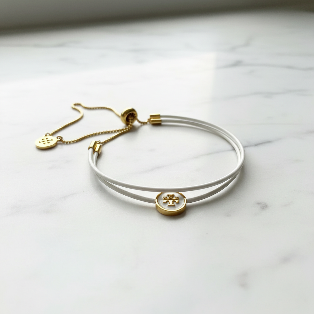 Tory Burch White Enamel Slider Bracelet on marble