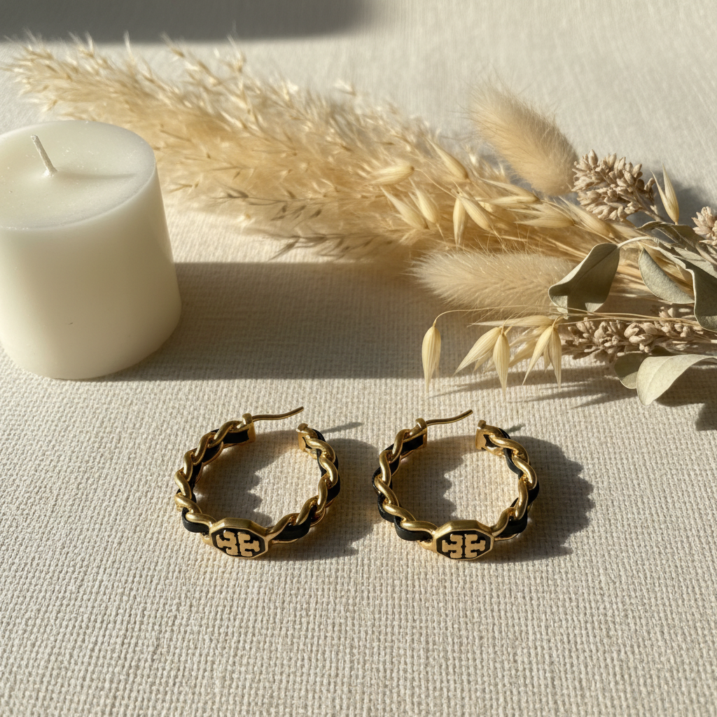 Tory Burch Marion woven hoop earrings styled with candle and botanicals